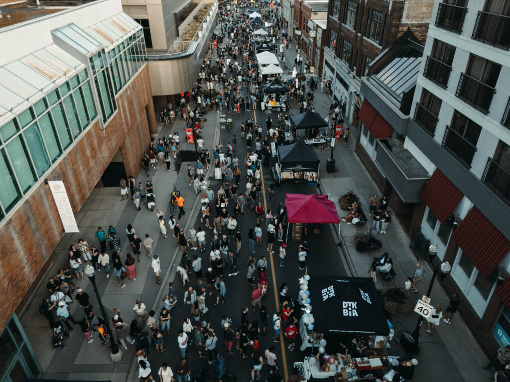Aerial view of King Street East during the Far East Asian Night Market. Street is lined with food vendors, craft vendors and folks soaking in the sights, sounds and scents.