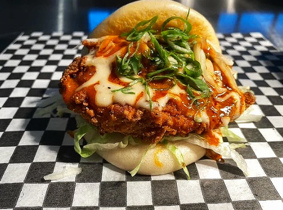 Bao Sandwich plated on a black and white checkered tablecloth. Vendor: Bao Sandwich Bar