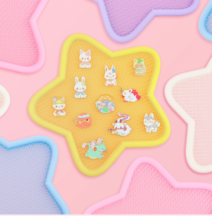 A yellow star pin display showcases an array of acrylic pins. Vendor: Tokyo Shojo
